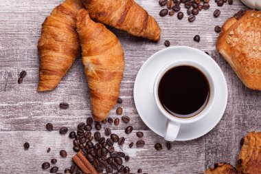 Kahve ve taze pişmiş tereyağı kruvasan vintage ahşap tablo