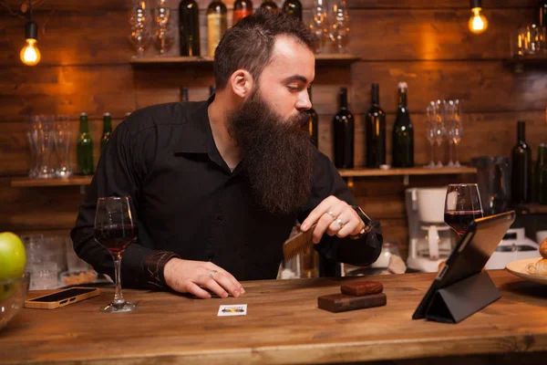 Hipster camarero cuidando de su larga barba . —  Fotos de Stock