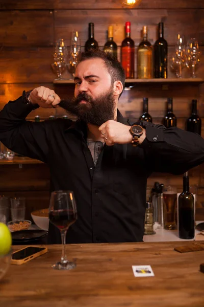 Bearded barman being funny with his beard — Stock Photo, Image