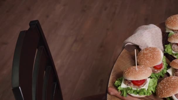 Dynamic reavealing shot of fast food on a wooden table — Stock Video