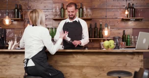 Cameriera al bancone di un bar che racconta appassionatamente una storia al barista — Video Stock