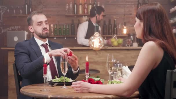 Bearded young man offers a diamond ring to his girlfriend — Stock Video