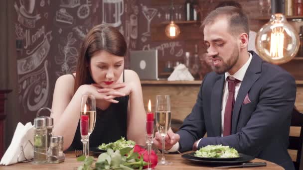Young woman gets bored on a date and starts to argue with her boyfriend — Stock Video