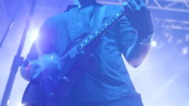 Elektro gitar ile Rocker bir müzik etkinliğinde bir seyirci önünde gerçekleştirir