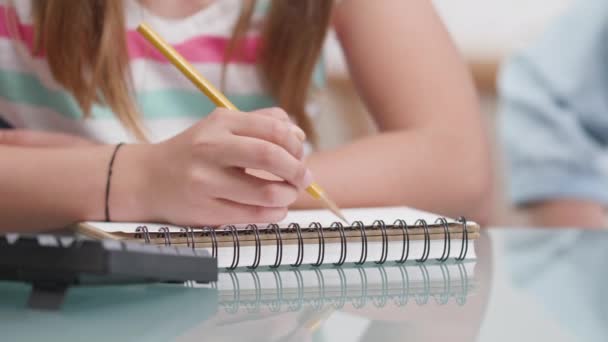 Las niñas manos con un dibujo a lápiz en un cuaderno — Vídeo de stock
