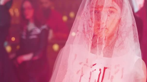 Tiener meisje vermomd als een dode bruid bedekt met bloed met een mes in haar hand — Stockvideo