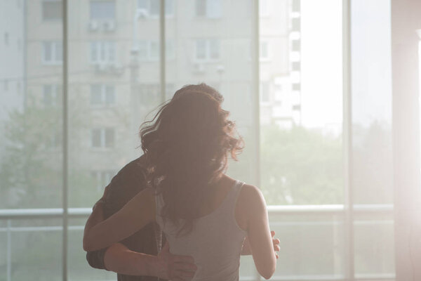 Professional dancers in big studio hall reharsing their dance