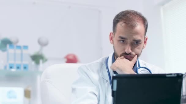 Prise de vue à la main du visage du médecin regardant le comprimé PC — Video