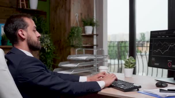 Geschäftsmann in modernem Büro mit großen Fenstern, die am Computer arbeiten — Stockvideo