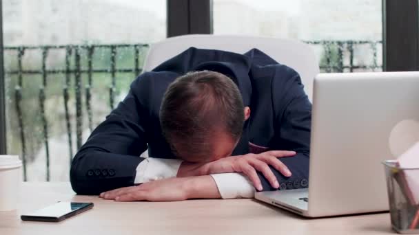 Bliska strzał z wyczerpany biznesmen śpi na jego biurku — Wideo stockowe