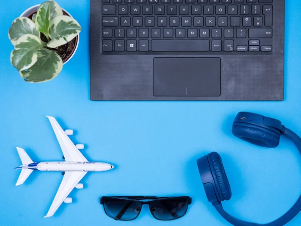 Flat lay top view desk of traveler programator over blue background