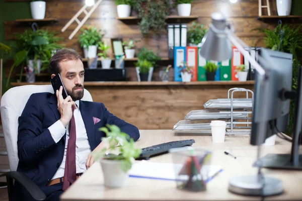 Heandsome skäggiga affärsman i kostym havine konversation på sin mobiltelefon — Stockfoto