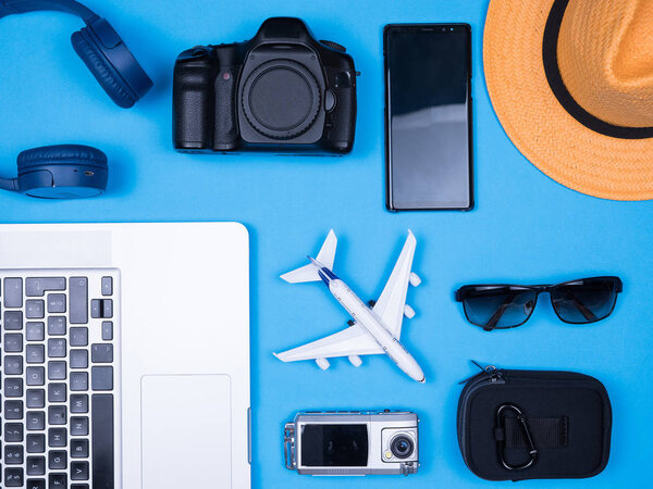 Flat lay traveler accessories over blue background