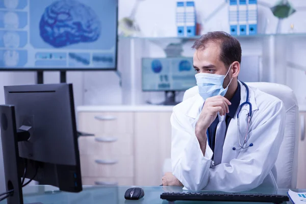 Doctor in white coat checking the next surgery for the day — Stock Photo, Image