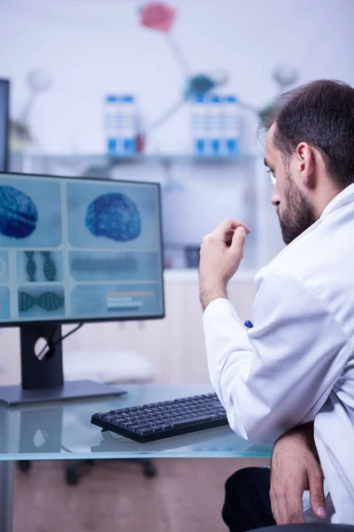 Médico ambicioso especializado en problemas neurológicos mirando el cerebro de un paciente — Foto de Stock