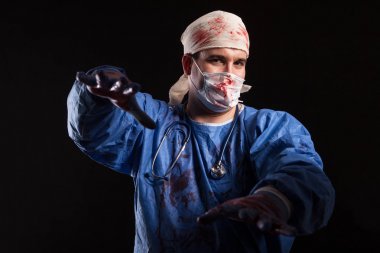 Crazy Doctor with a surgeon mask and scrubs splattered with blood for halloween clipart