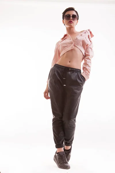 Full body portrait of beautiful fashion modeling looking down on the camera wearing a stylish pink jacket — Stock Photo, Image