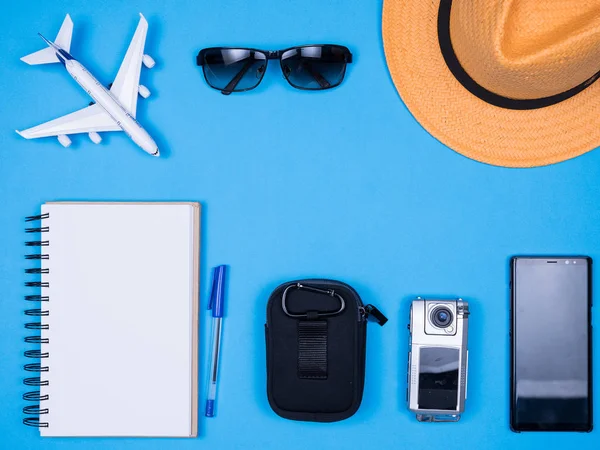 Flat lay top view accessories of traveler journalist over blue background — Stock Photo, Image