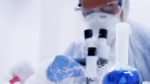현미경에 대한 연구를 하는 덮개 장비의 과학자 — 비디오