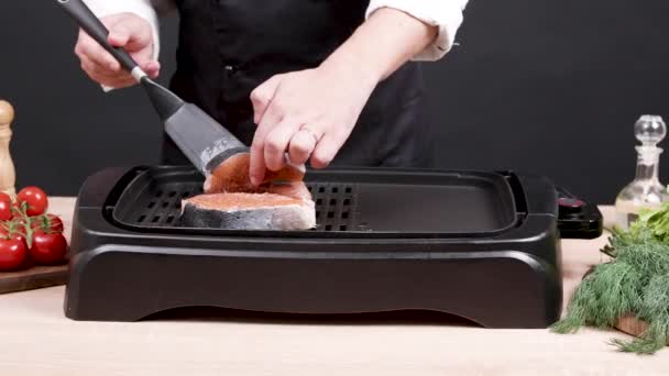 Chef preparing salmon seasoned with mediterranean herbs — Stock Video