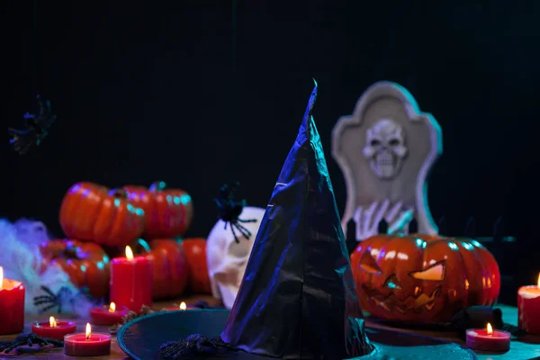 Scary witch hat sitting on a wooden table celebrating halloween — Stock Photo, Image