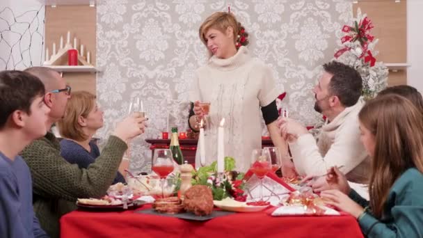 Woman holding a glass of champagne and making a toast — Stock Video