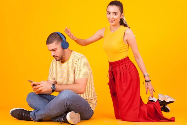 Namorado usando seu telefone enquanto namorada tentando chamar sua atenção — Fotografia de Stock