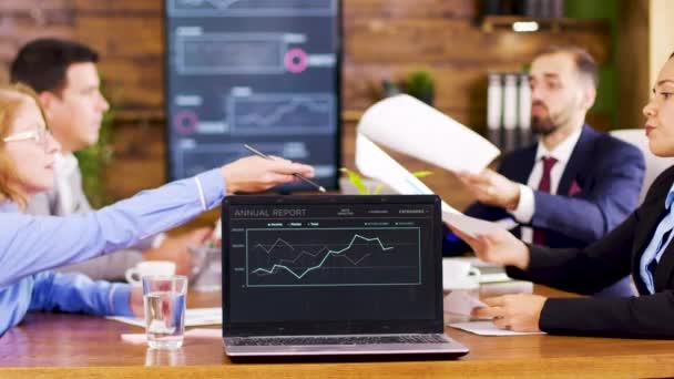 On the table laptop showing charts in the conference room — Stock Video