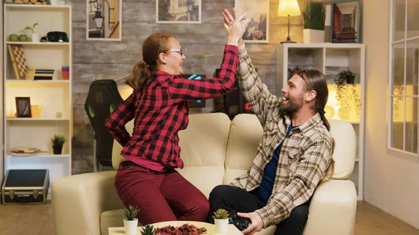 Couple celebrating victory while playing video games — Stok fotoğraf