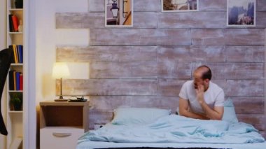 Yorgun adam uyku maskesini takıyor.