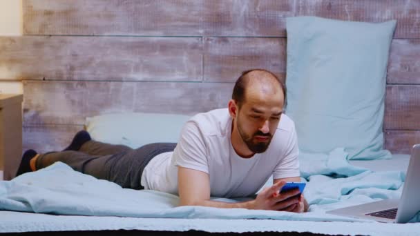 Caucasian man scrolling through social media on his phone — Stock Video