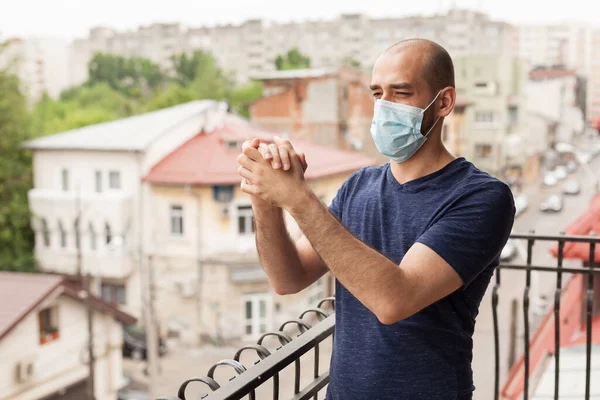 Happy man clapping on balcony