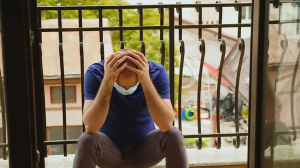 Depressed man with disposable mask