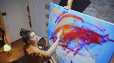 Sanat stüdyosunda resim yapan kişi.