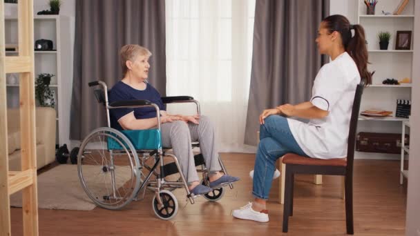 Nurse checking on retired handicapped old woman — Stock Video