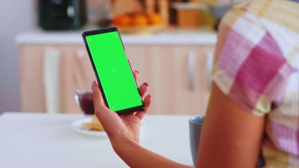 Woman looking at phone with green touchscreen — Stock Video