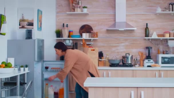 Frau holt Paprika aus Kühlschrank — Stockvideo