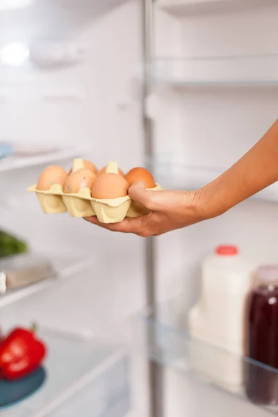 Picking up eggs from fridge — Stock Photo, Image