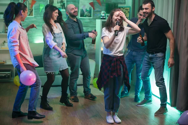 La joven no puede creer que esté haciendo karaoke. —  Fotos de Stock