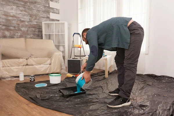 Pouring paint into the tray