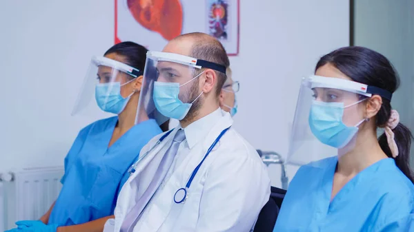 Personal médico con máscara facial en la sala de espera del hospital —  Fotos de Stock