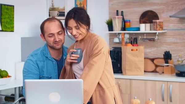 Happy entrepreneur couple working on laptop