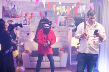 Cadılar Bayramı partisinde zombi gibi giyinmiş bir adam.