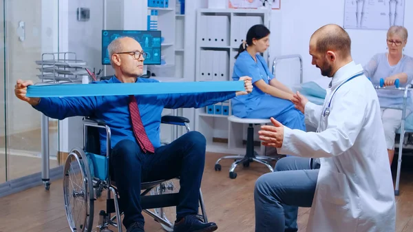 Handicapped injured man training with elastic band