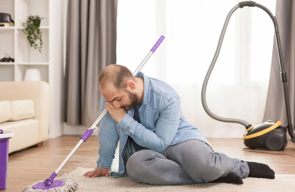 Tired man after cleaning the floor — Stock Photo, Image