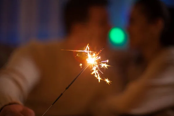 Couple in matching close holding bengal lights — Stock Photo, Image