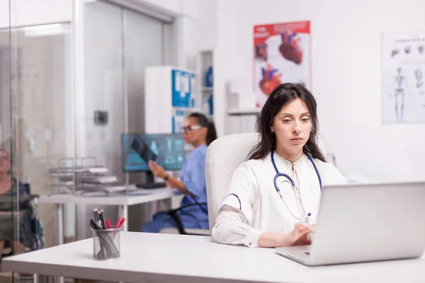Young therapist using laptop in clinic — Stock Photo, Image