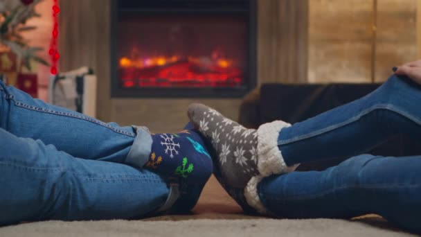Casal usando meias de lã na frente da lareira — Vídeo de Stock