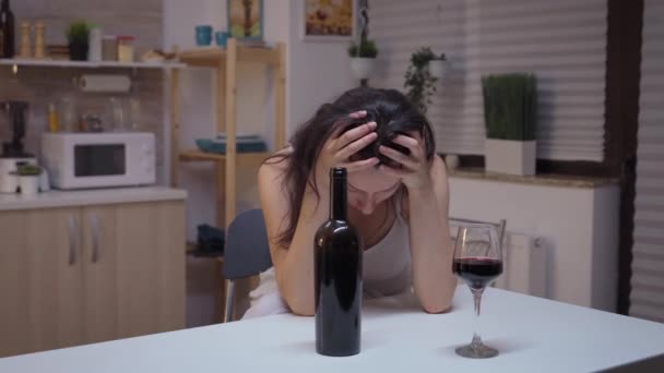 Пьяная женщина сидит на кухне — стоковое видео