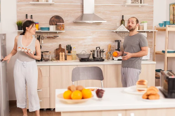 Wife taking eggs from refrigerator — Stock Photo, Image